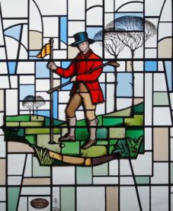 stained glass image of golfer holding flag
